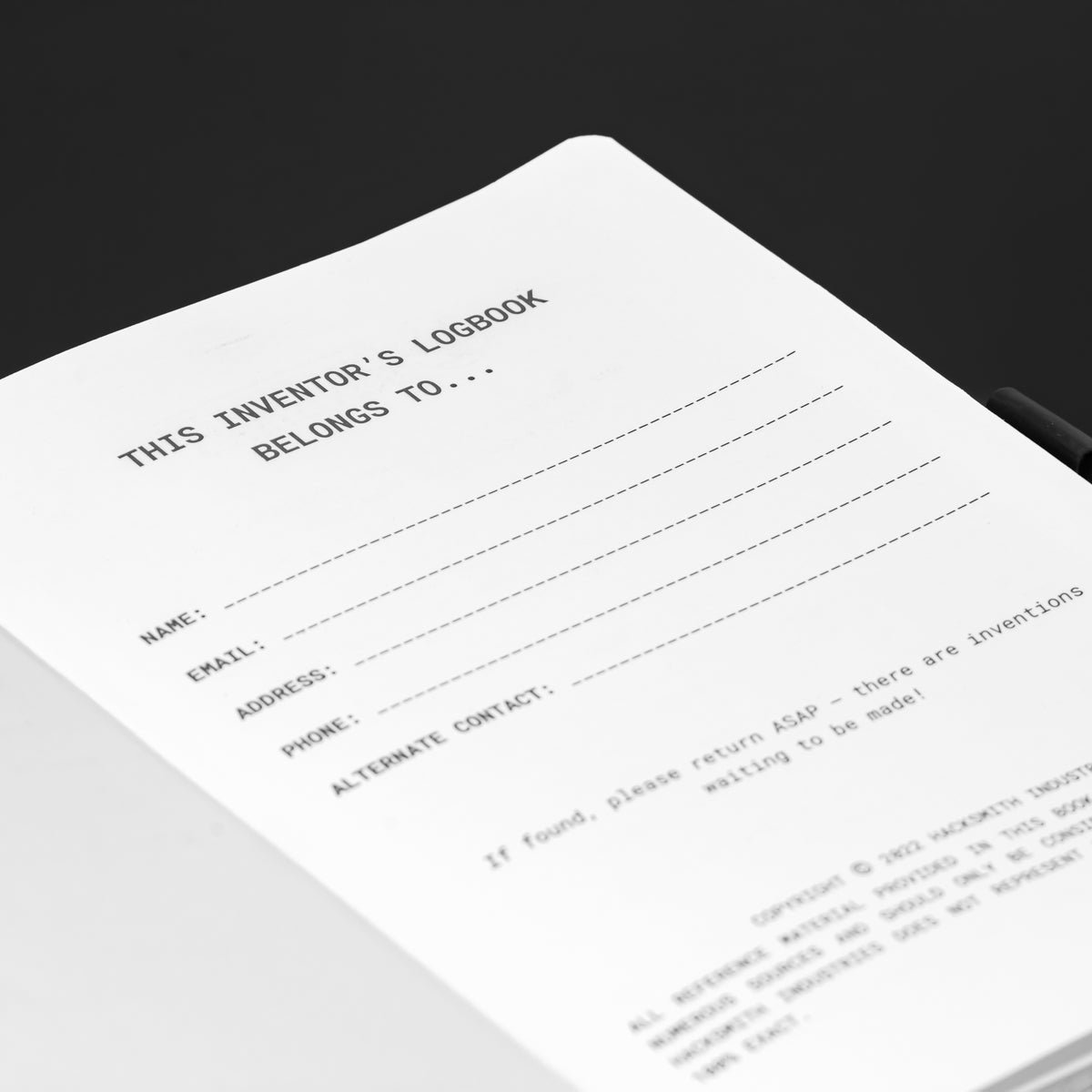 Close-up of The Inventor's Notebook Add-on by Engineered By Hacksmith, showing its cover with detailed design and branding.